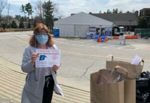Good Samaritan Hospital representative accepts D99 face shield donations.